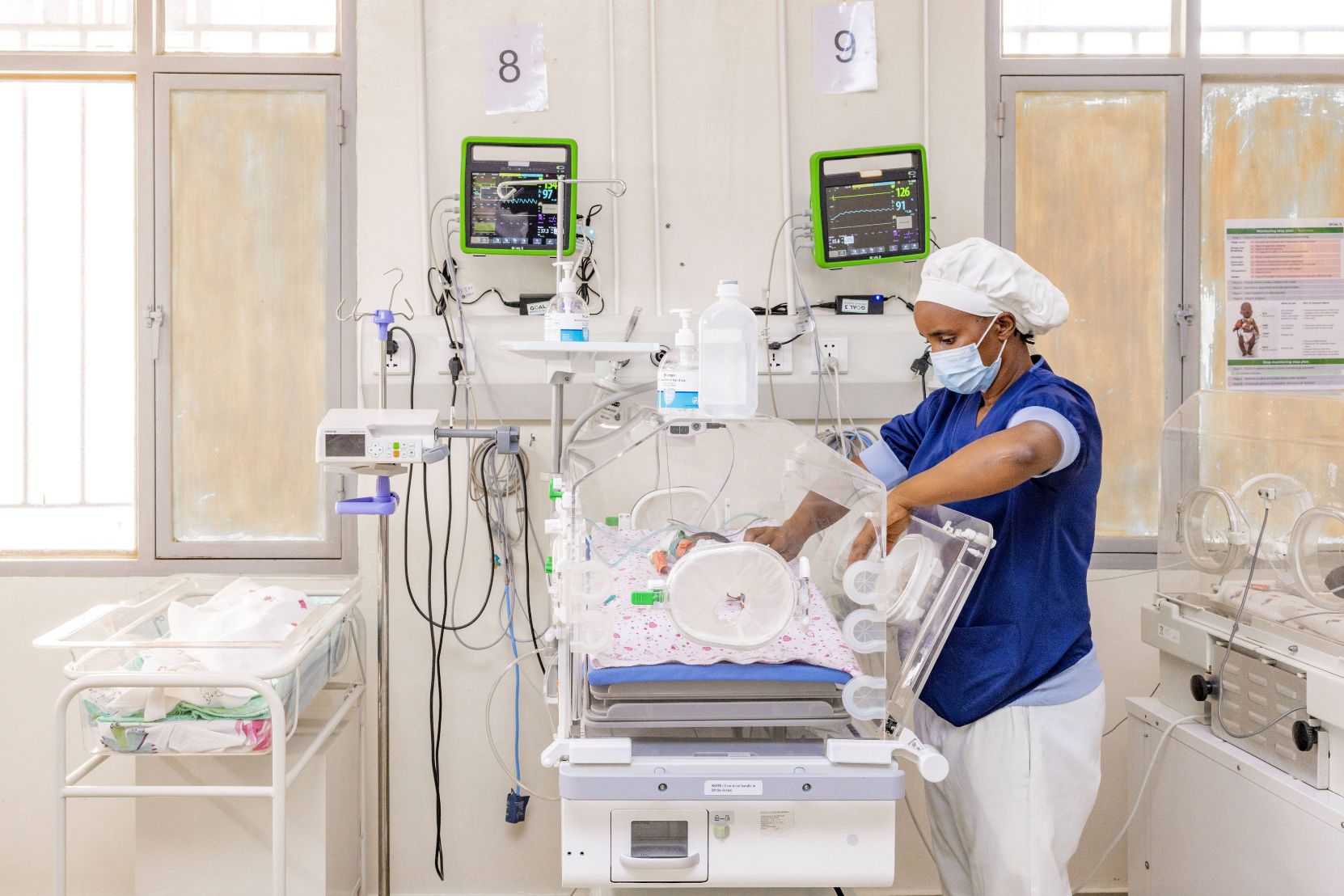 A nurse monitoring a newborn
