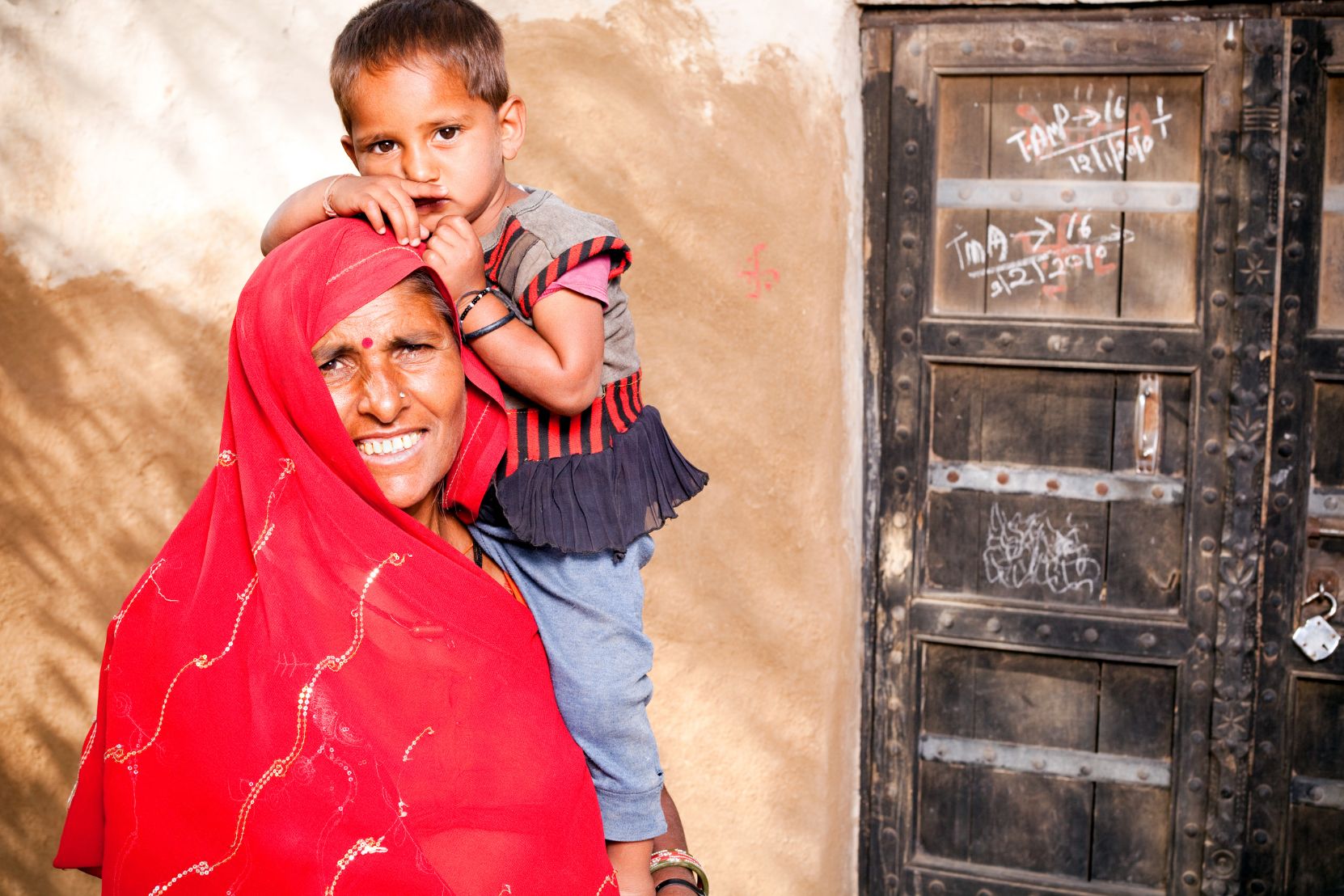A mother and daughter smiling